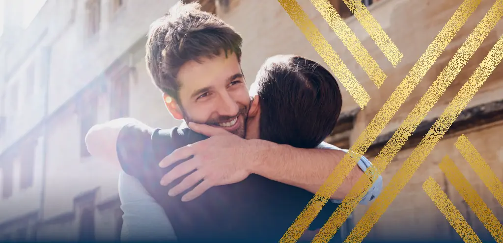Two men hug in celebration, highlighting the availability of UK civil partner visas in 2024.