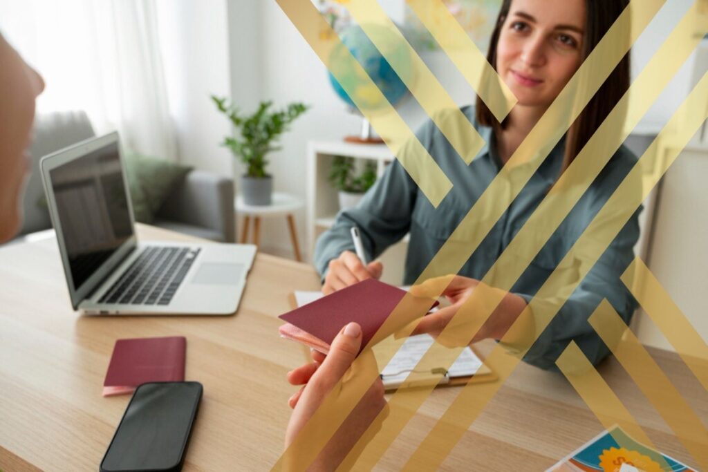 A woman smiles while holding a passport in one hand and a laptop in the other, ready for her travels.