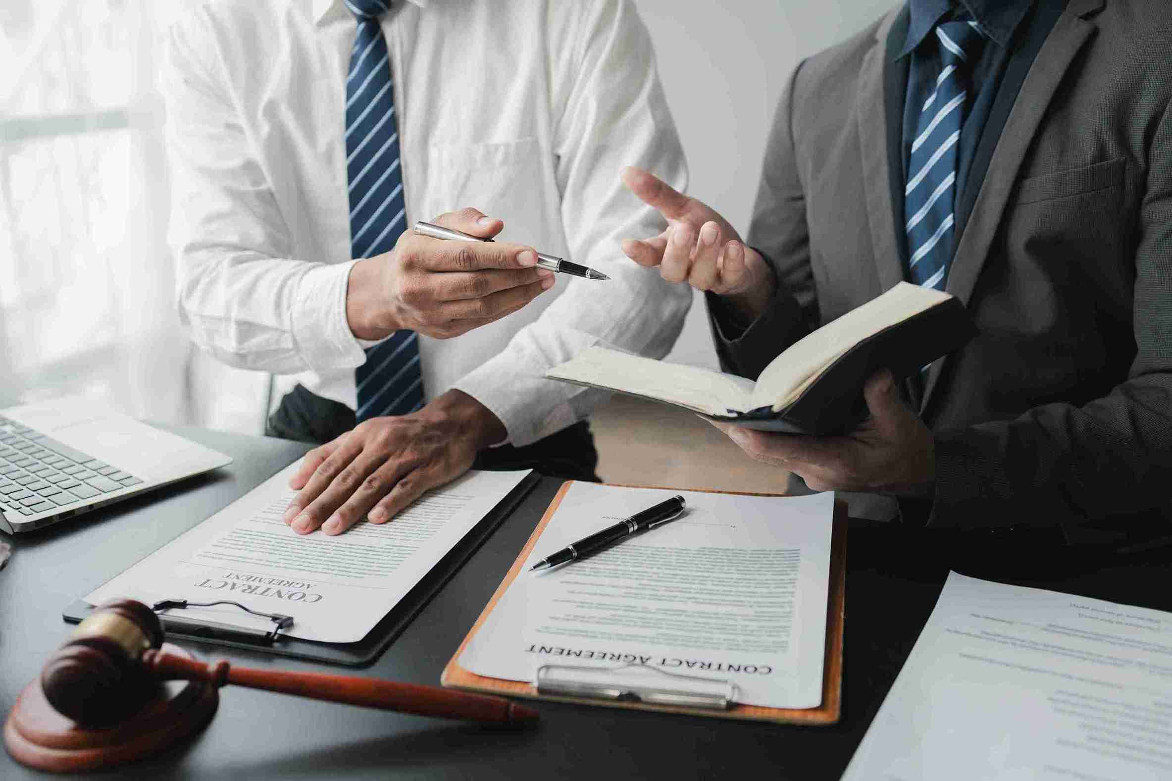 Commercial Litigation A Comprehensive Guide to Key Processes, Legal Implications, and Strategies (Business man sitting with his lawyer discussing the commercial disputes and litigation steps)