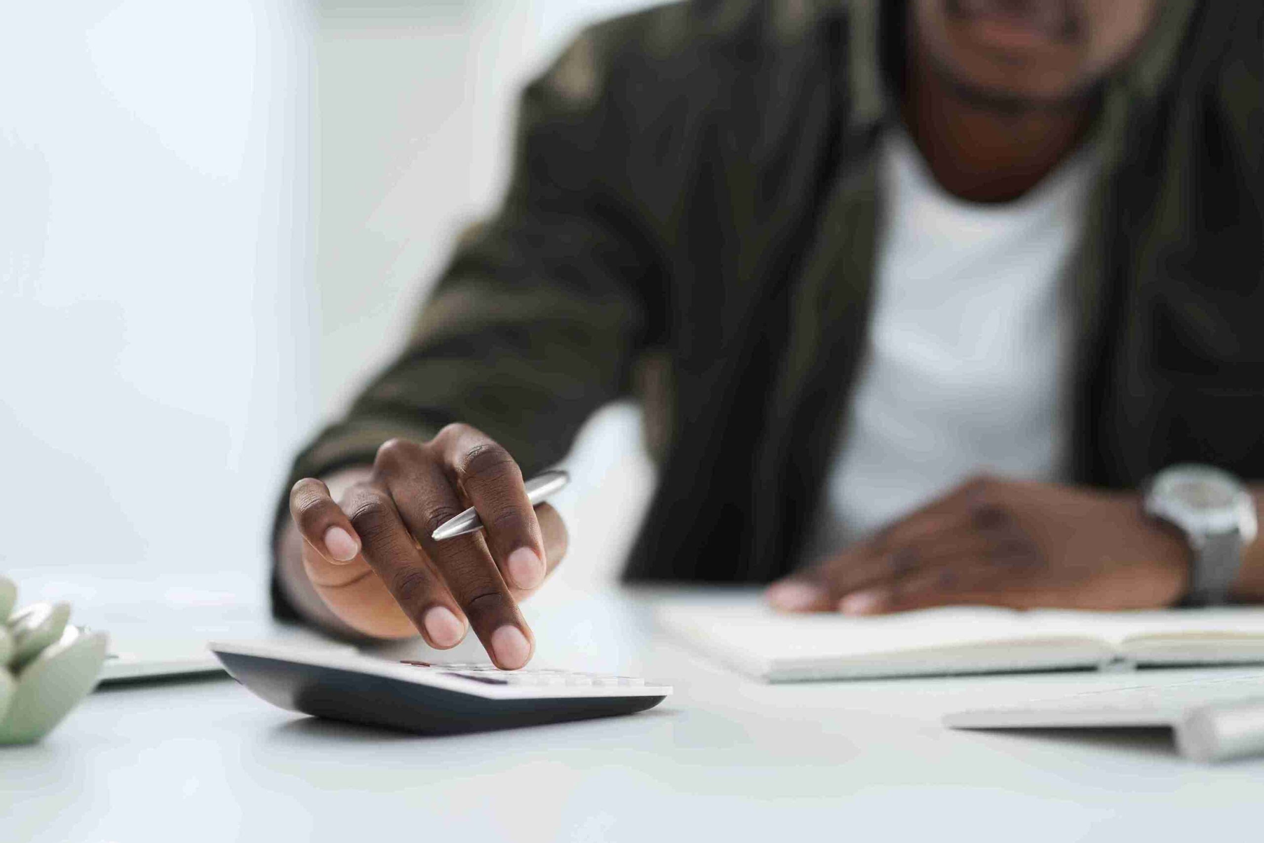 Man Calculating Salary Thresholds Under the UK Immigration Salary List.