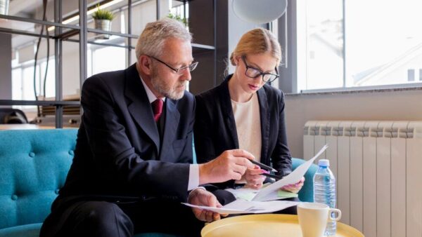 (Senior solicitor discussing with his assistant the new compliance and obligations) 