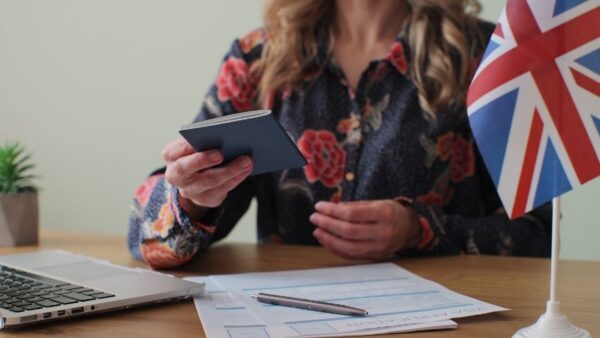 (In the image a woman can be seen explaining all the requirements for UK Visa)