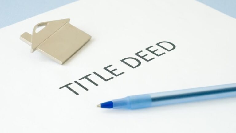 (In the image it can be seen a paper is there having title deed written along with a property symbol) What Do Property Title Deeds UK Look Like