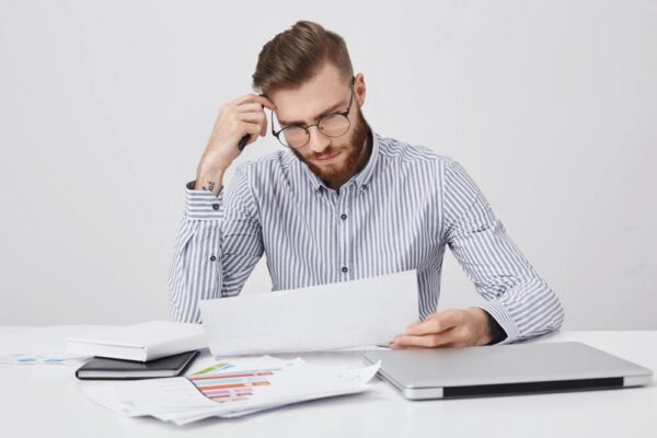 What Happens If You Can’t Pay Civil Litigation Costs-min (A worried person looking at all the pending expenditures for civil litigation)