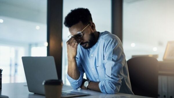 (In the image a person can be getting stressed over corporate dispute consequences) 
