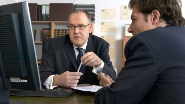 (Solicitor and client discussing to ensure maximum chances of debt recovery)