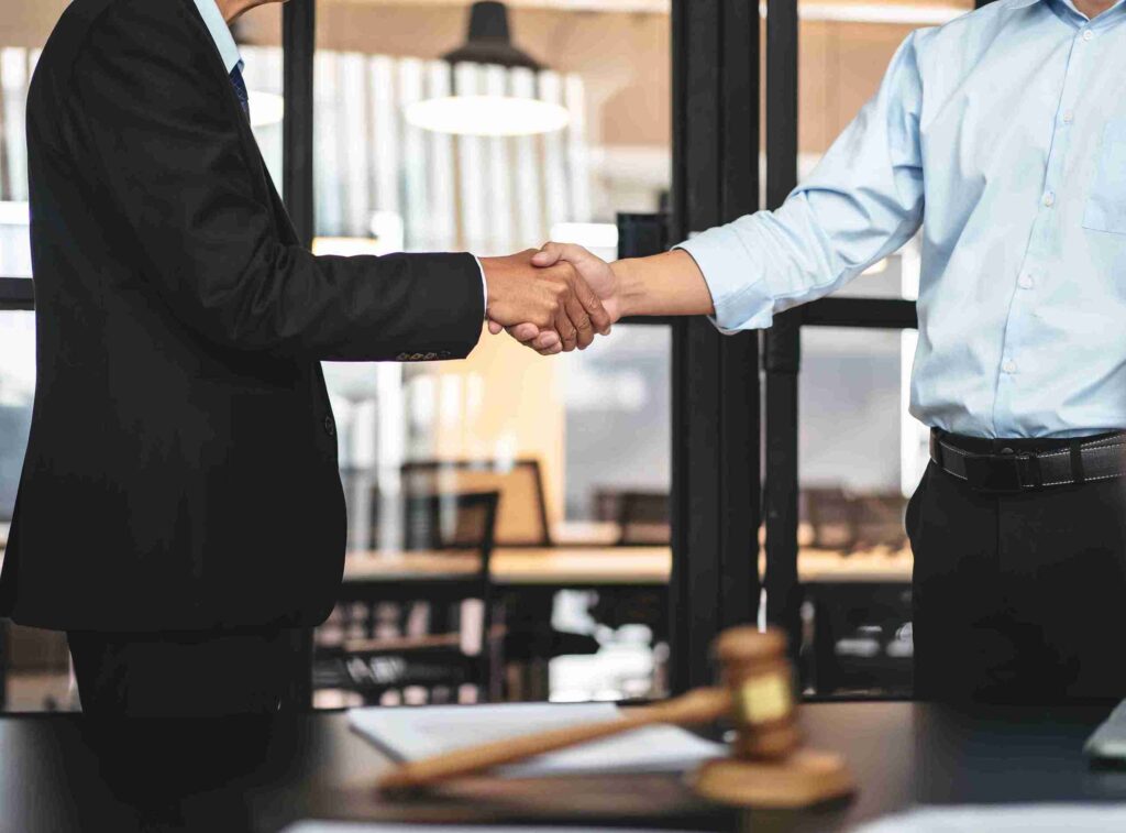 In the image it can be seen a businessman is holding a gavel in his hand symbolising commercial dispute and litigation