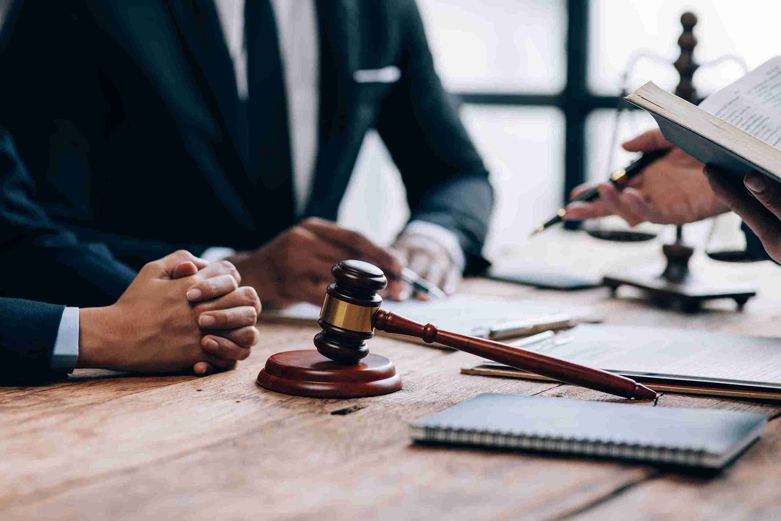 In the image it can be seen a solicitor is discussing legal and procedural risks with his client