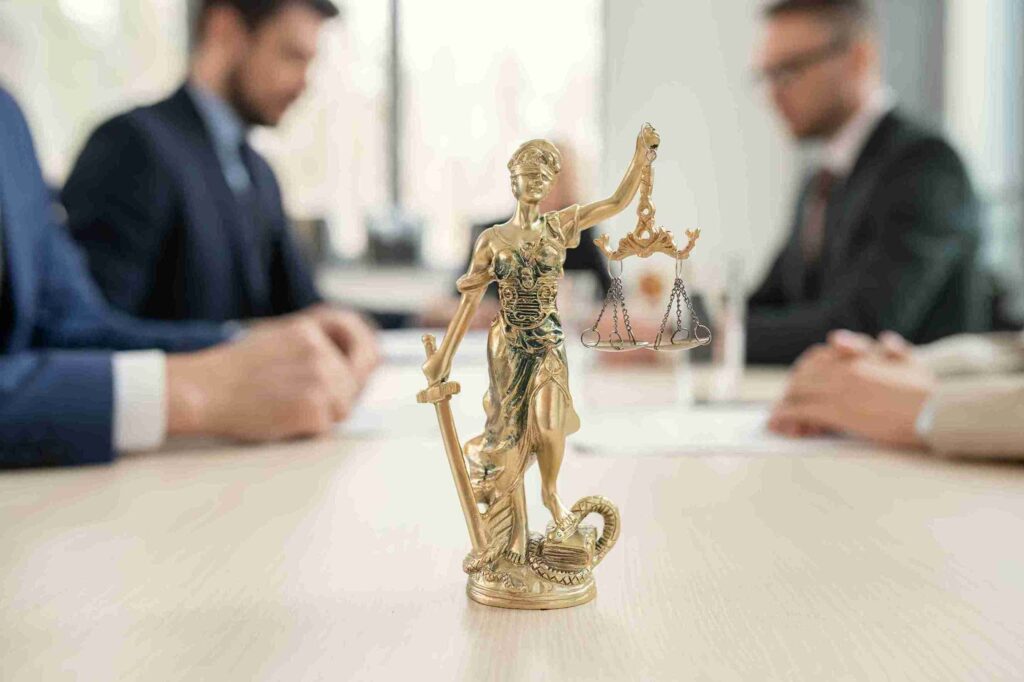 In the image a discussion between solicitors regarding Group litigation orders can be seen.