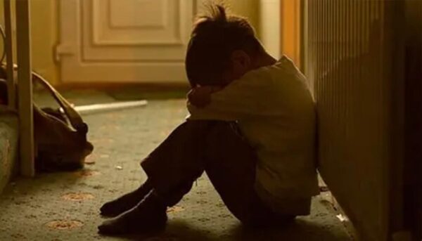 Vulnerable child sitting in his room