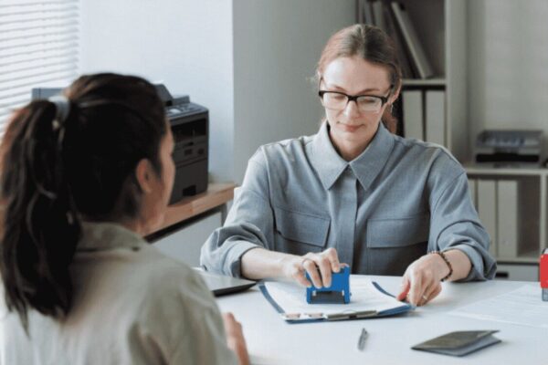 UK Immigration Rules 2025: Key Changes and What They Mean for Applicants two assistance specialists are discussing the Language requirements and integration expectations