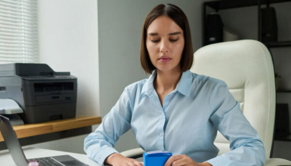 Complete Guide to Further Leave to Remain UK Visa Applications for Students An international student representative processing a Further Leave to Remain UK application at an office desk.