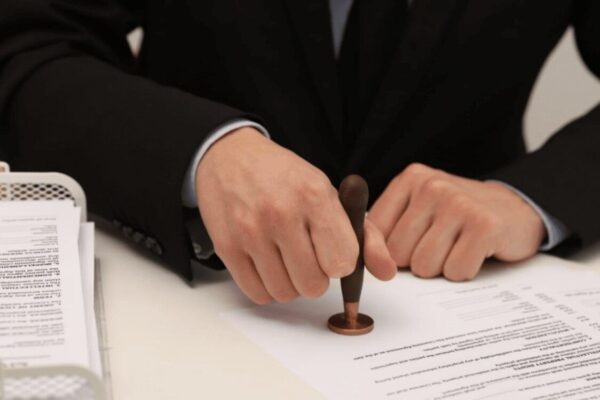 Copyright Infringement: Definition, Meaning, Example, and Criteria Sealing a legal document, representing the formal process of registration, licensing, or handling a copyright breach.