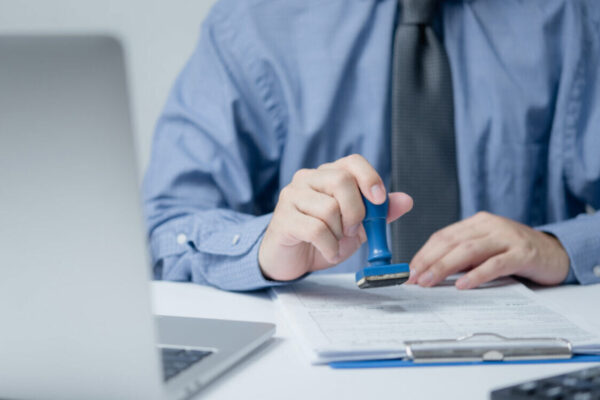 Brexit Update: Key Immigration Changes in 2026 Affecting Work, Family, and Business A legal official stamping a UK visa application form, illustrating compliance with new immigration rules UK and Brexit Update 2026 procedures.