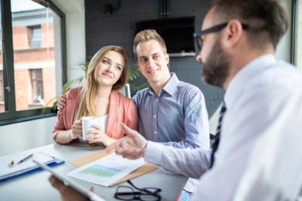 (A couple receiving professional guidance on meeting the genuine relationship test UK criteria during a formal consultation.)