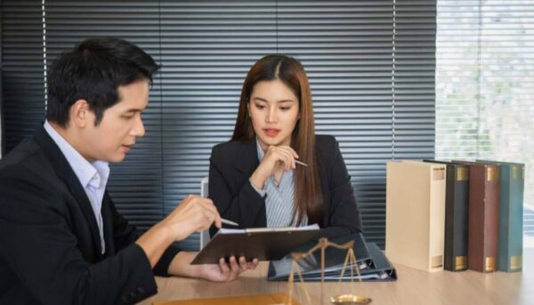 Immigration lawyer advising a client on their ILR application and requirements.