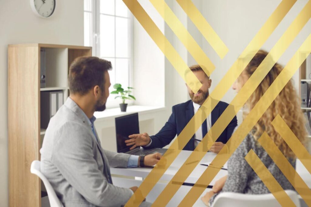An immigration solicitor advising a couple on UK spouse visa fees and long-term application planning in a professional office.