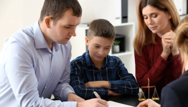 Child arrangement order being signed by parents with a solicitor, showing the process of a structured parenting plan