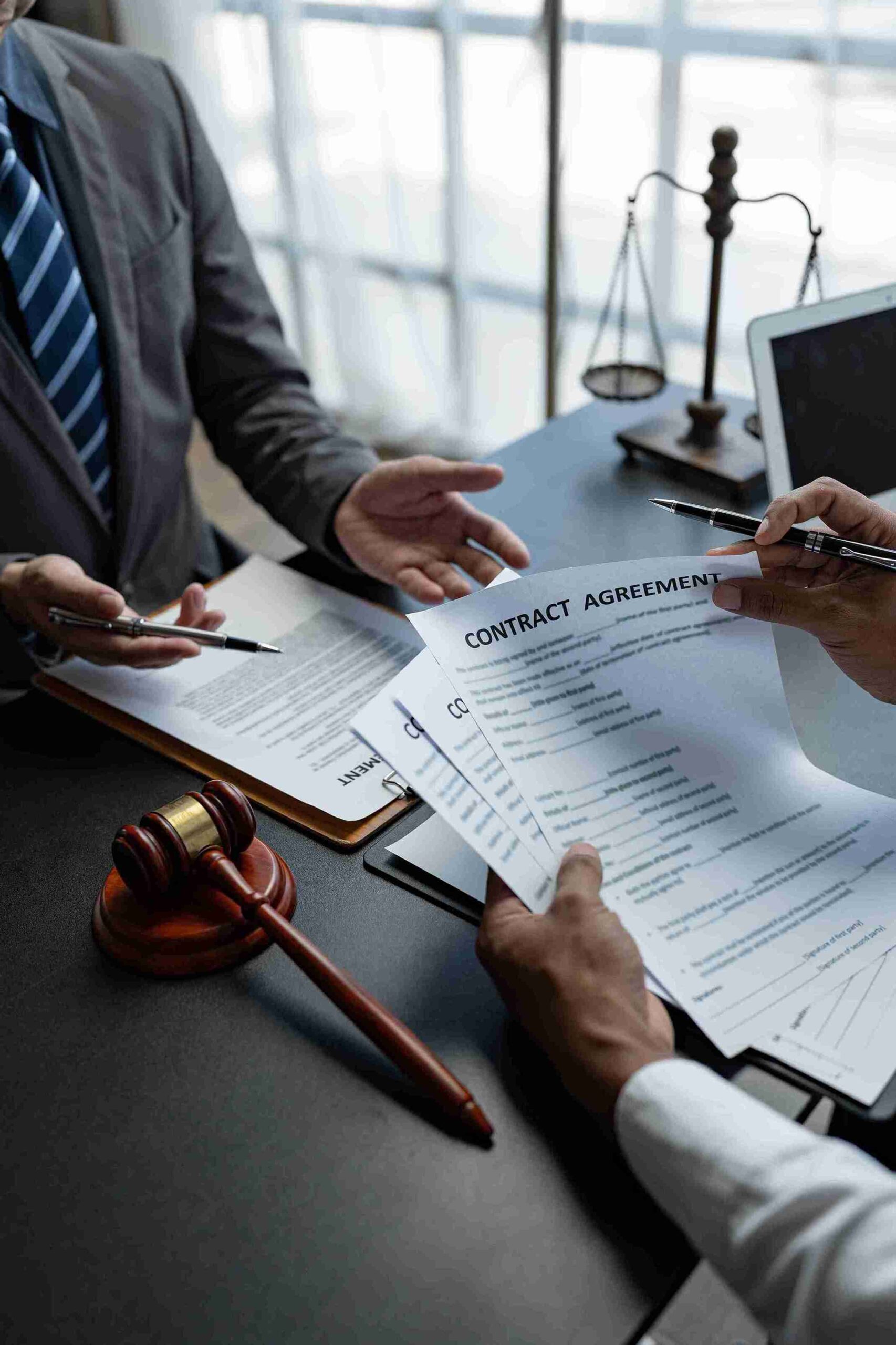 Lawyer professionals reviewing documents with gavel and scales, showing expert legal working for UK immigration outcomes