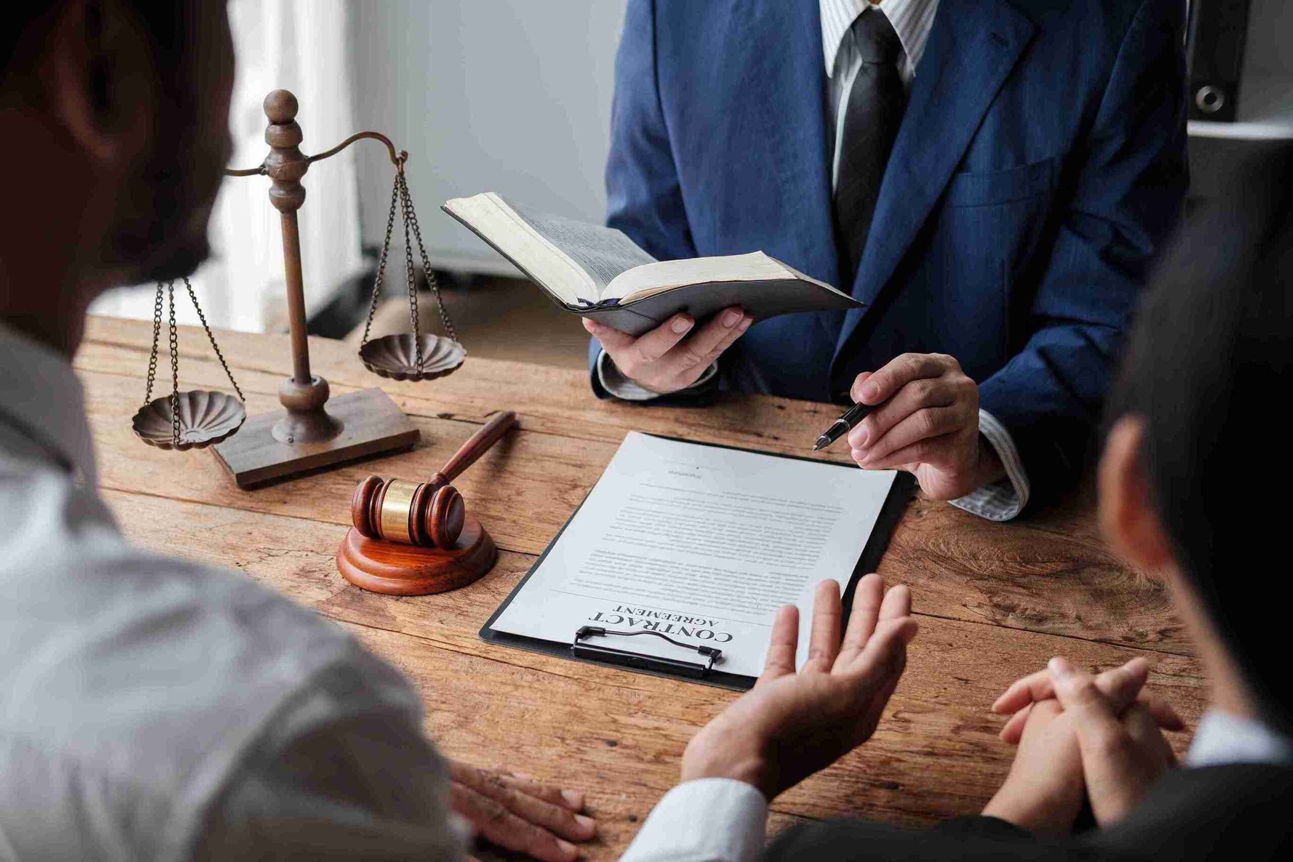 Lawyer in blue suit reviewing contract with scales and gavel, providing expert legal guidance for UK immigration appeal.