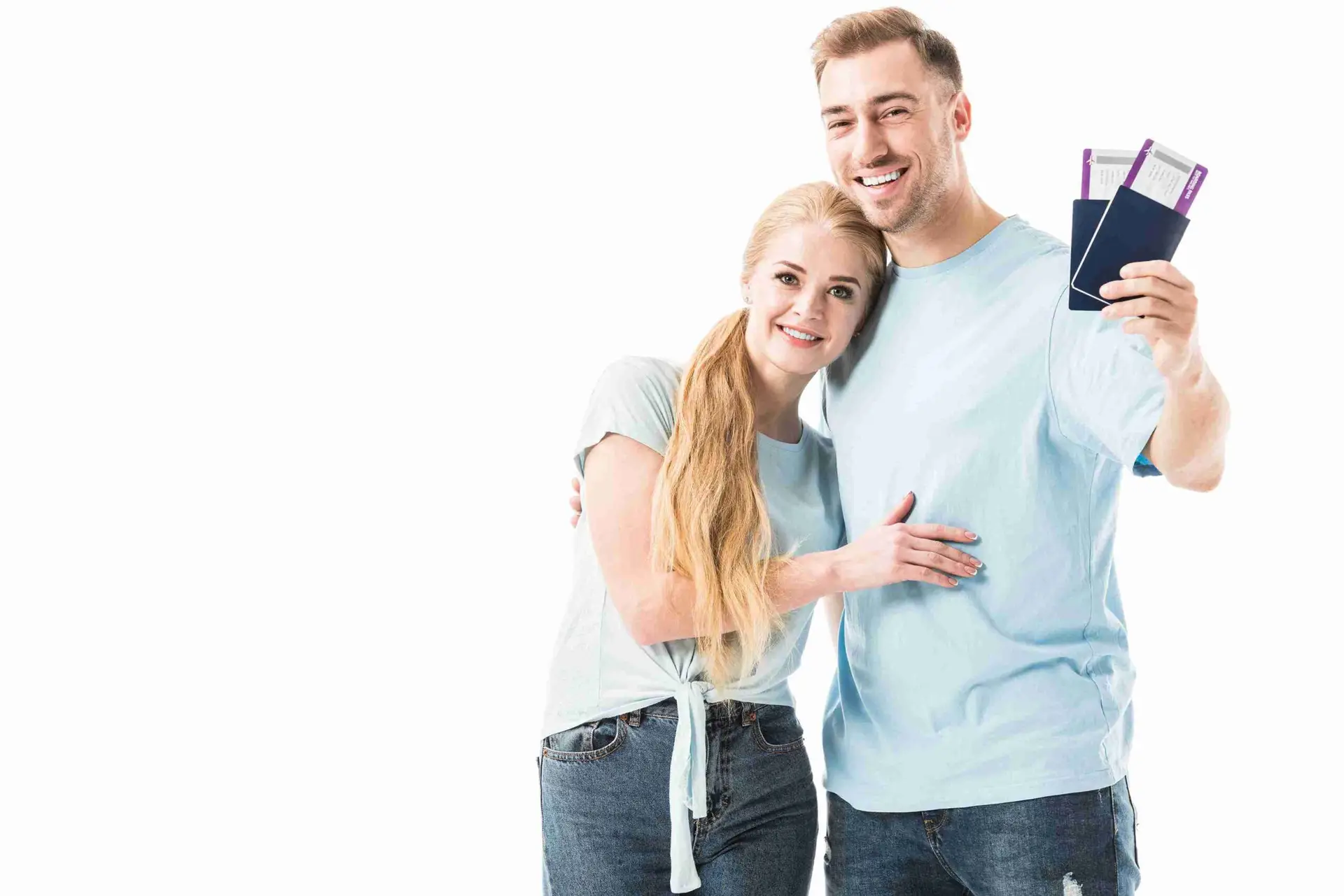 A man and woman proudly display their passports, symbolizing their journey towards a spouse visa application.