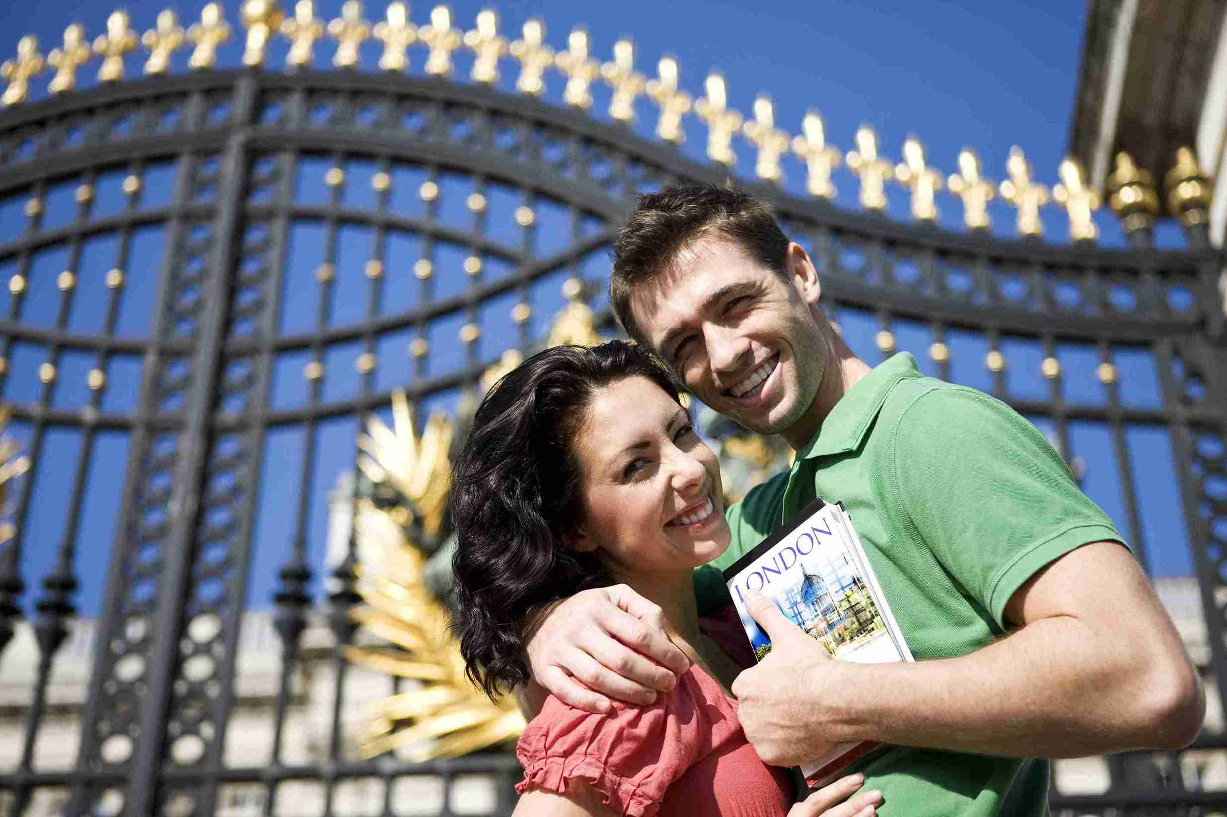 A man and woman stand together in front of a decorative gate, symbolizing their journey for a Morocco Spouse Visa.