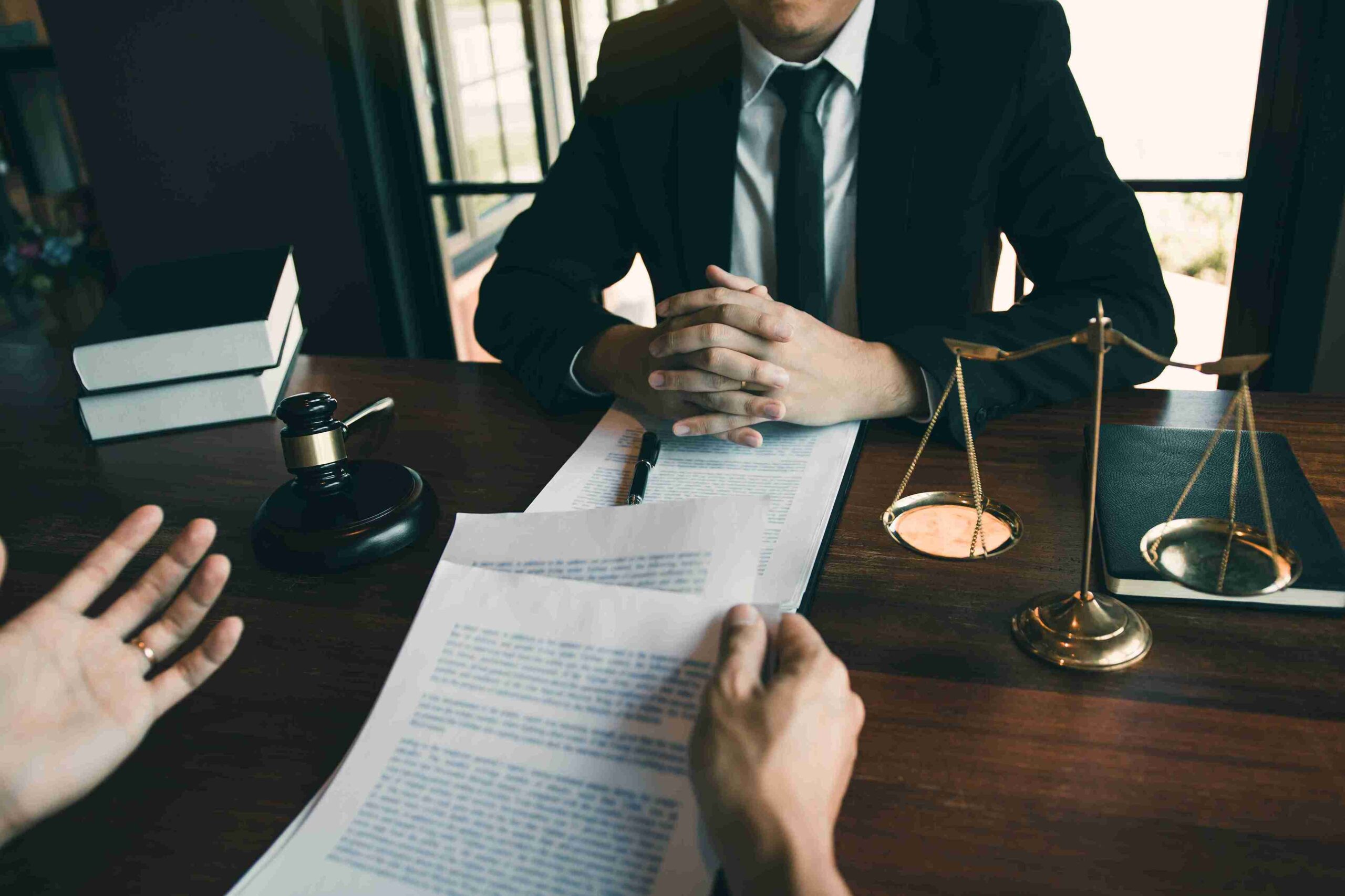 Lawyer meeting with client at office.