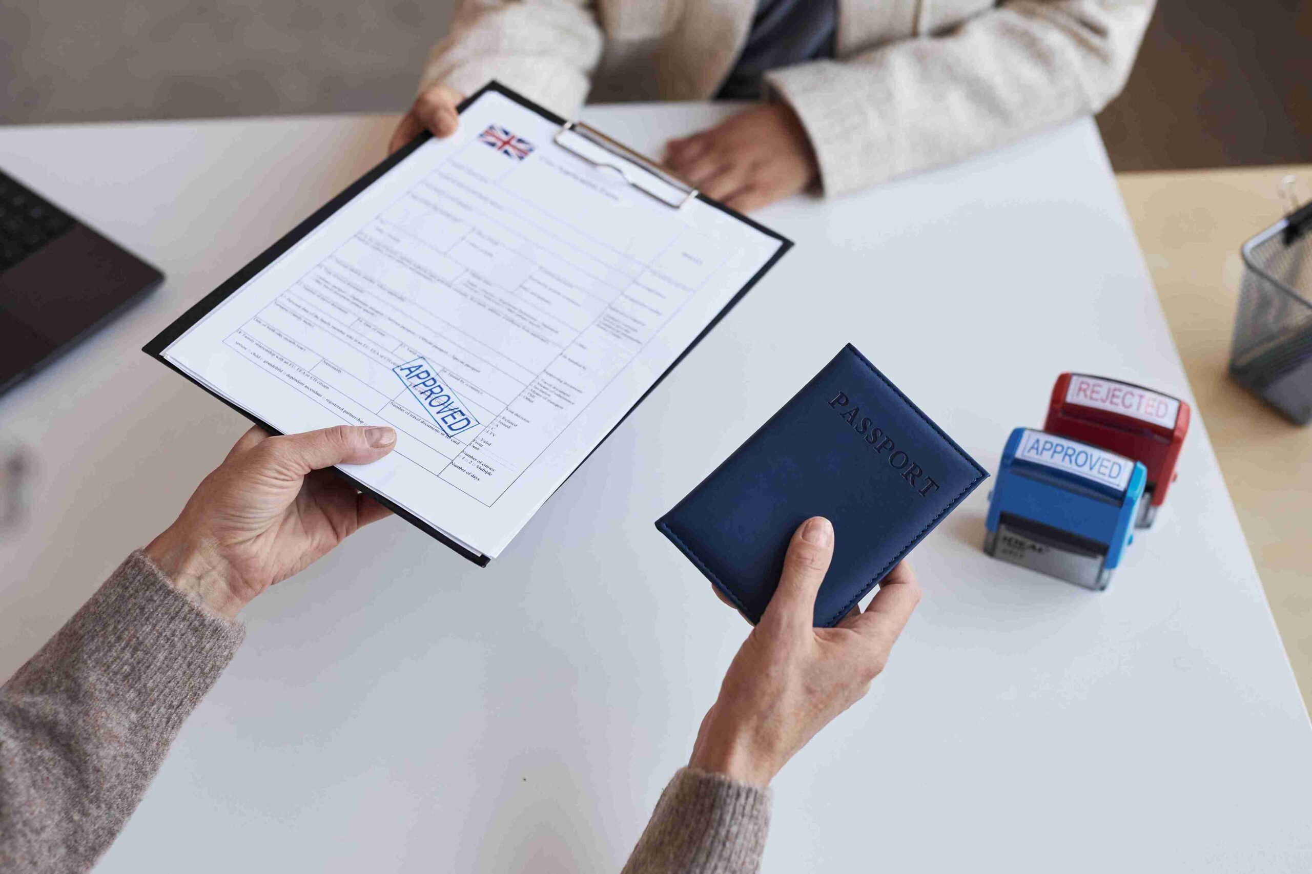 A person holding a passport in one hand and a passport book in the other, ready for travel.