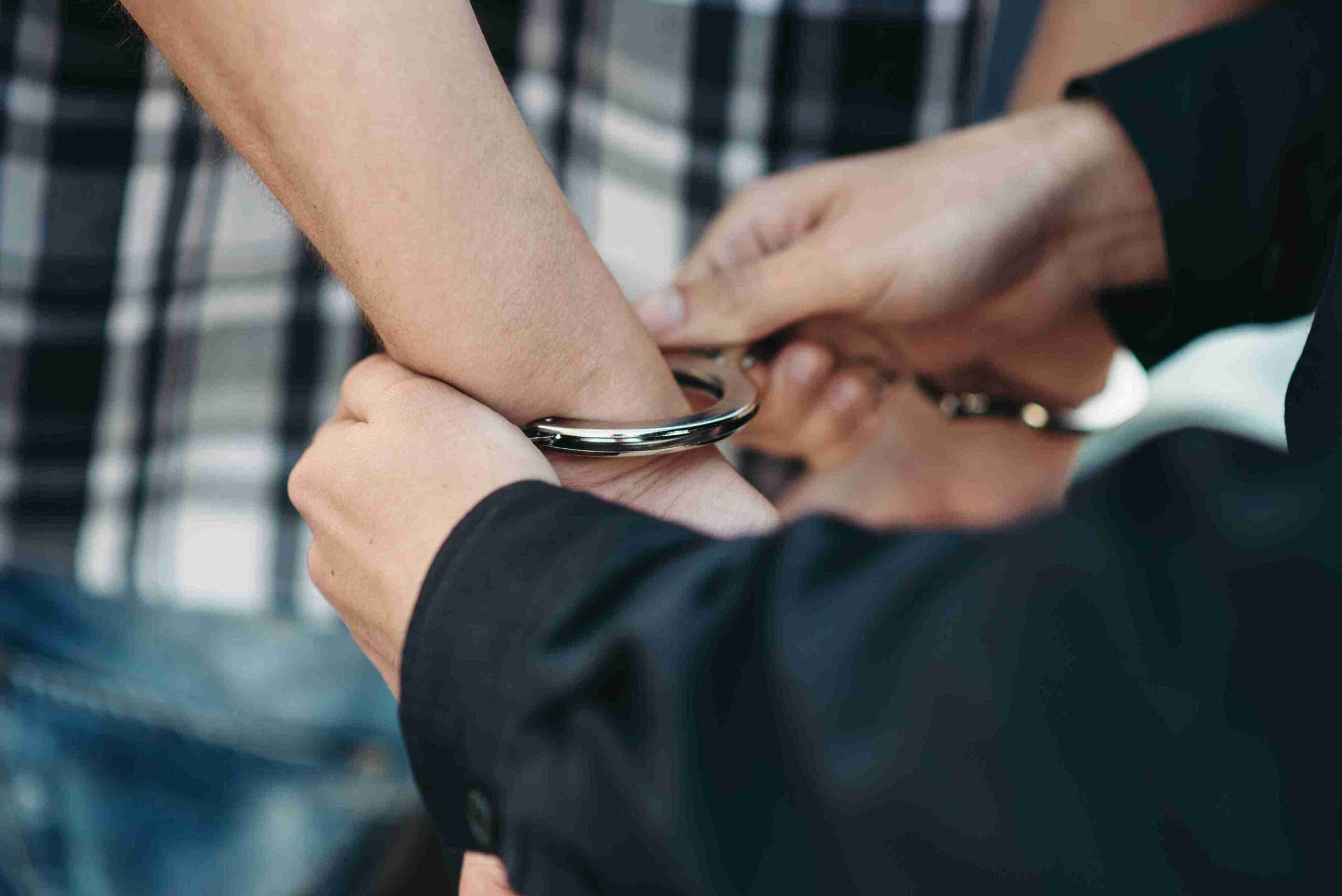 A man holds a wrist cuff in his hand, showcasing its design and texture.