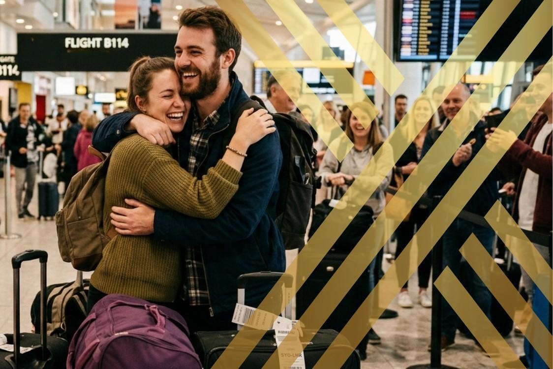 Couple joyfully reuniting at an airport arrivals gate, embracing each other warmly while surrounded by their luggage, showing the successful application of fiance visa UK.