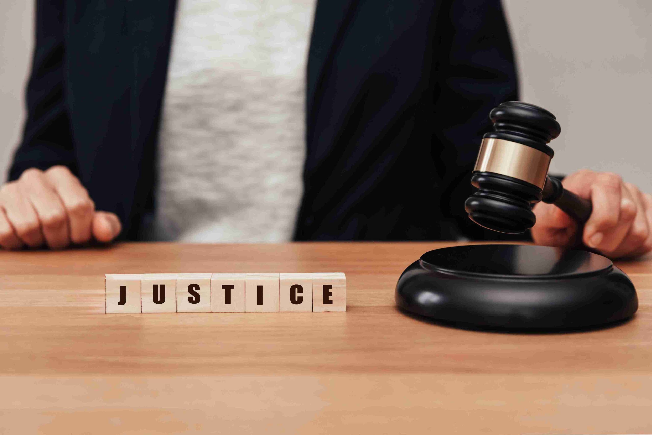 A judge presides over a courtroom, symbolizing justice with a gavel and legal books in the background.
