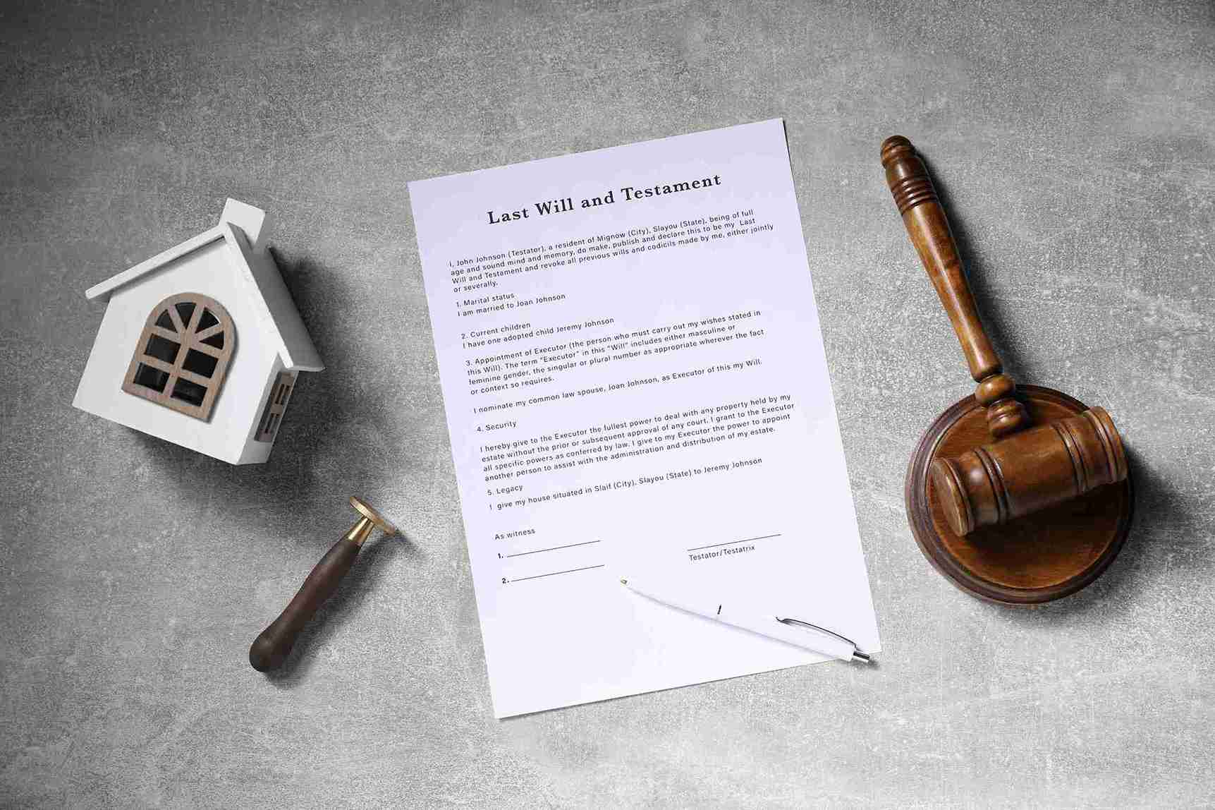 A house model and a gavel on a table beside a lease agreement paper, symbolizing real estate and legal matters.