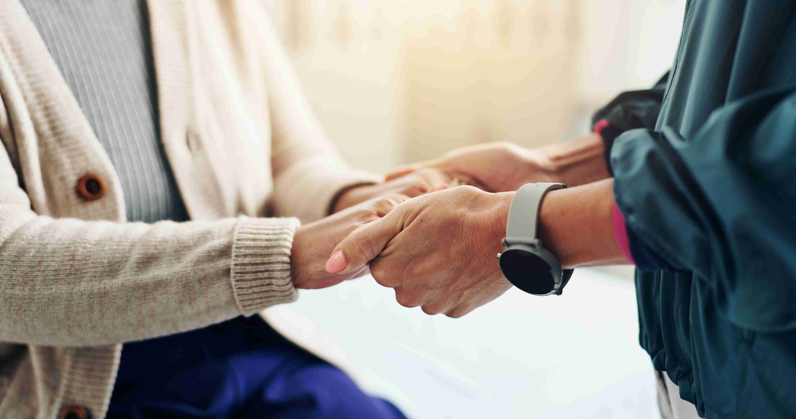 A person and another person shaking hands, symbolizing agreement or partnership.