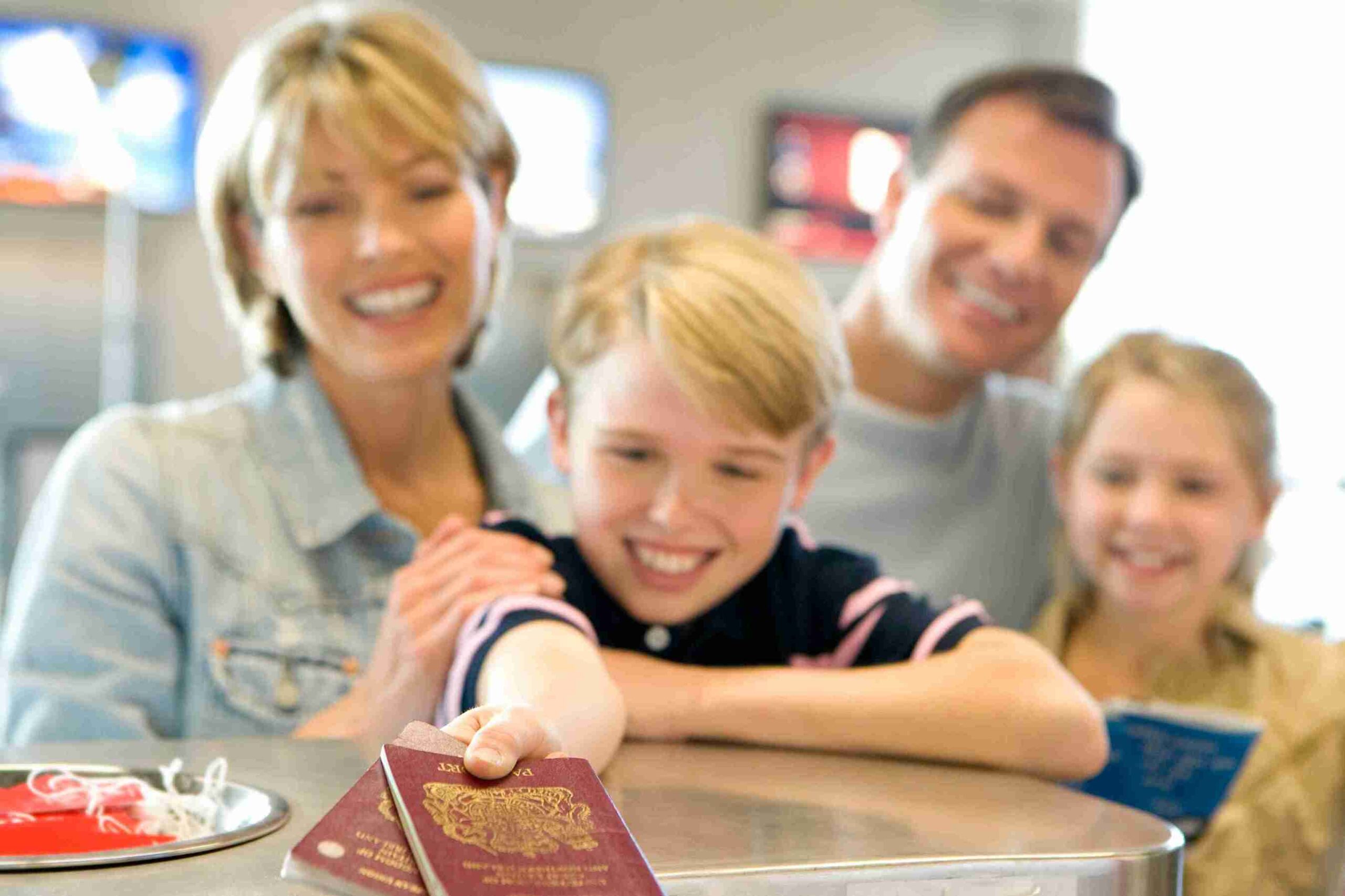 Little boy handling over passport at the check scaled.