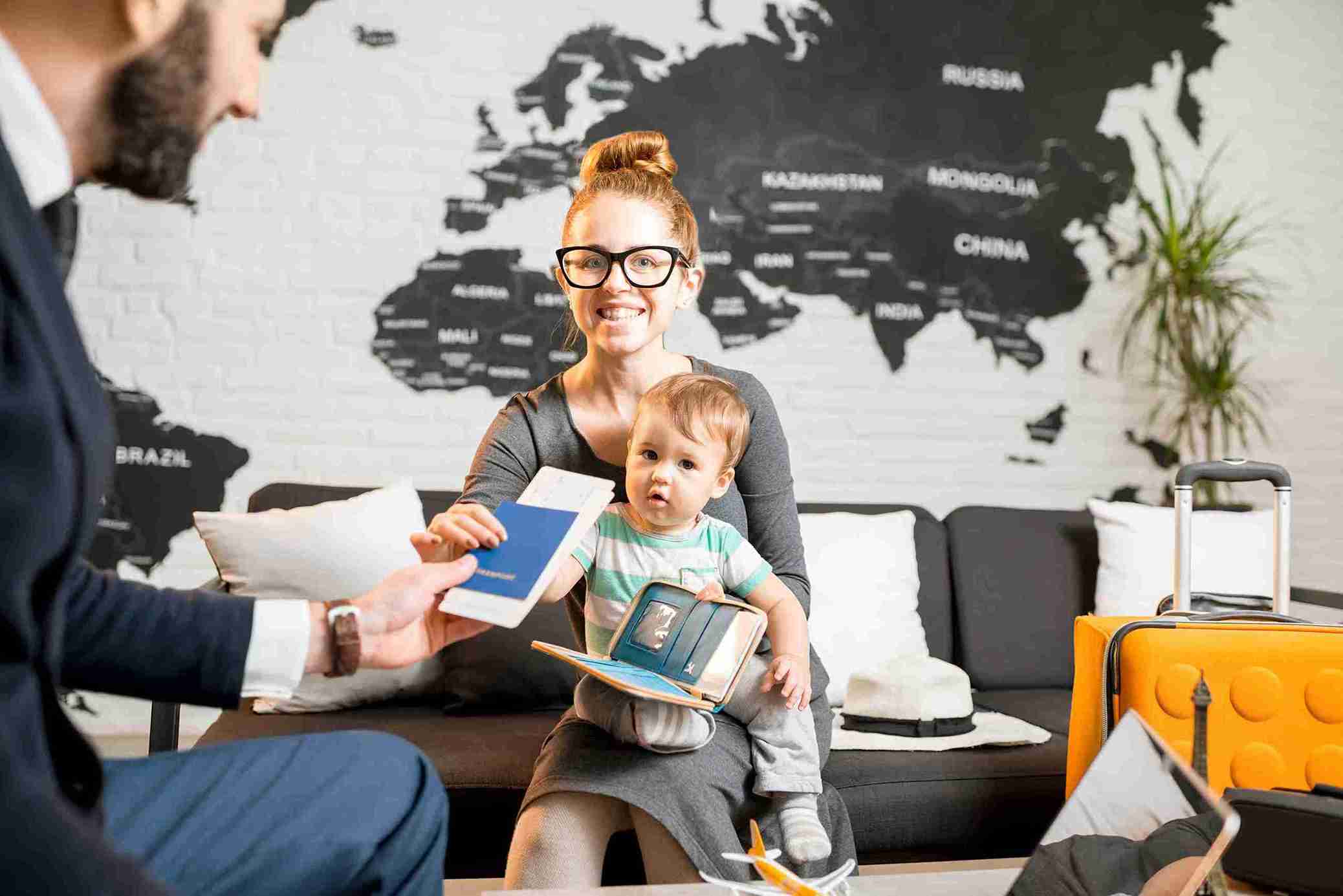 Woman and baby boy with travel agent at the office.