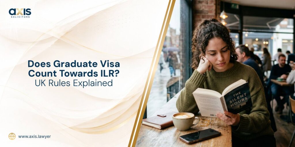 International student in a UK university cafeteria reading a book, considering Does Graduate visa counts towards ILR.
