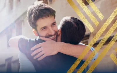Two men hug in celebration, highlighting the availability of UK civil partner visas in 2024.