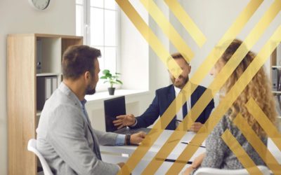 An immigration solicitor advising a couple on UK spouse visa fees and long-term application planning in a professional office.