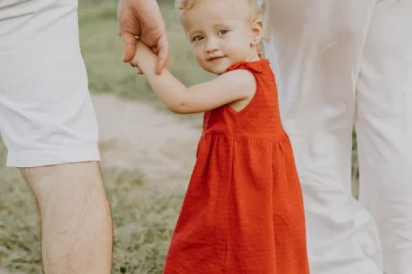 a photo of a child with its parents who are considering children matters in uk family law at axis solicitors.